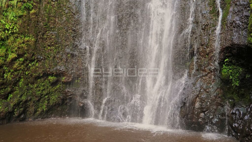 Wide Curtain Waterfall Pouring into Muddy Pool