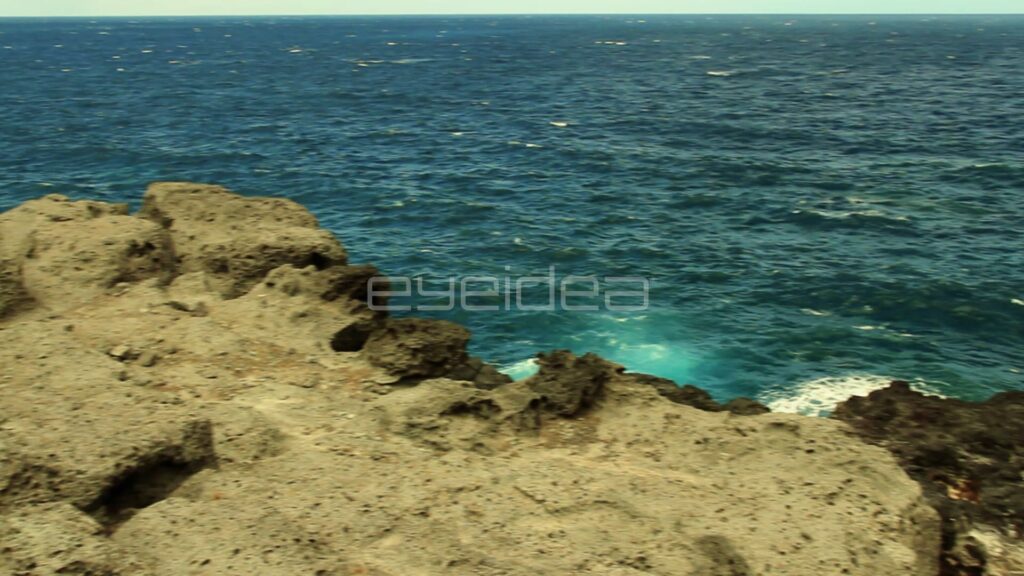 Waves Breaking Below Tan Rock Ledge on Maui Coast
