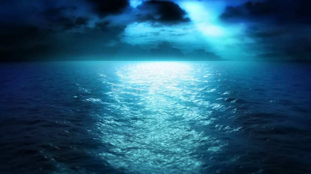 Moonbeam Breaking Through Dark Clouds Onto Rippling Sea