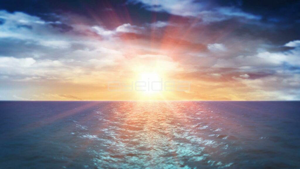Sun Bursting Through Blue and White Clouds Over Calm Ocean