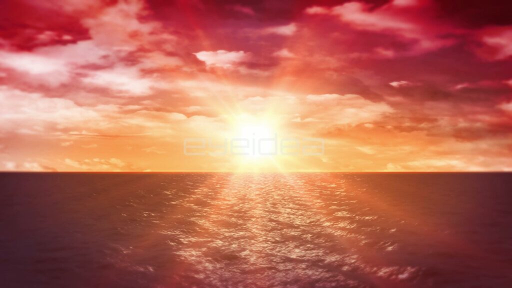Sun Low Over the Ocean Under Red and White Clouds