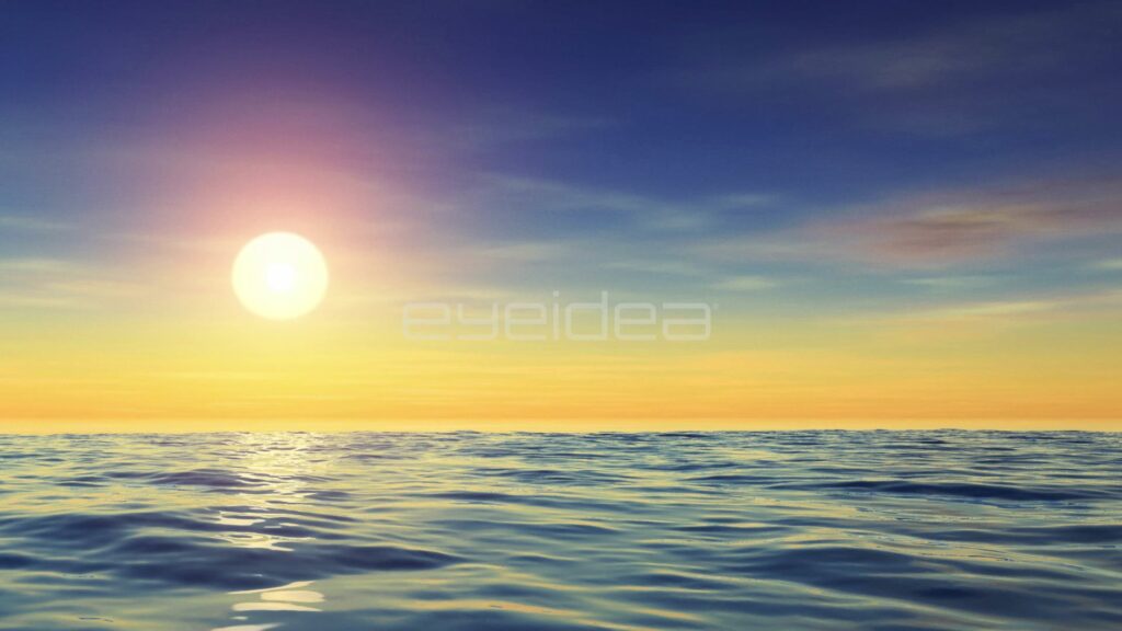 Bright Sun Low Over Calm Ocean in a Clear Golden Sky
