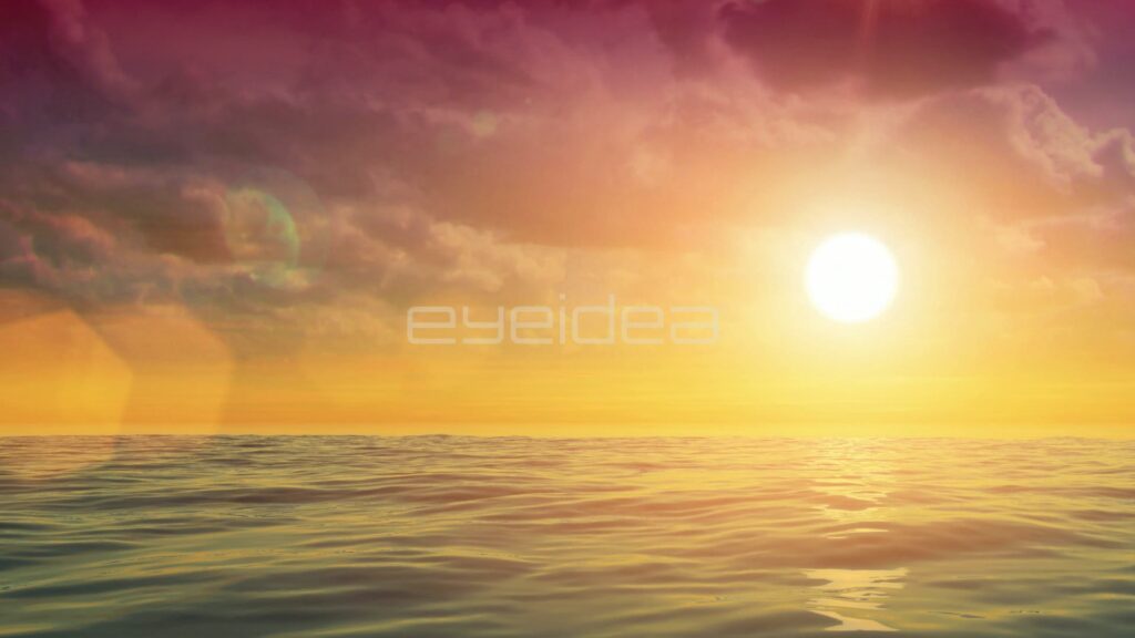 Sun Setting Behind Pink Clouds with Lens Flare Over Calm Sea