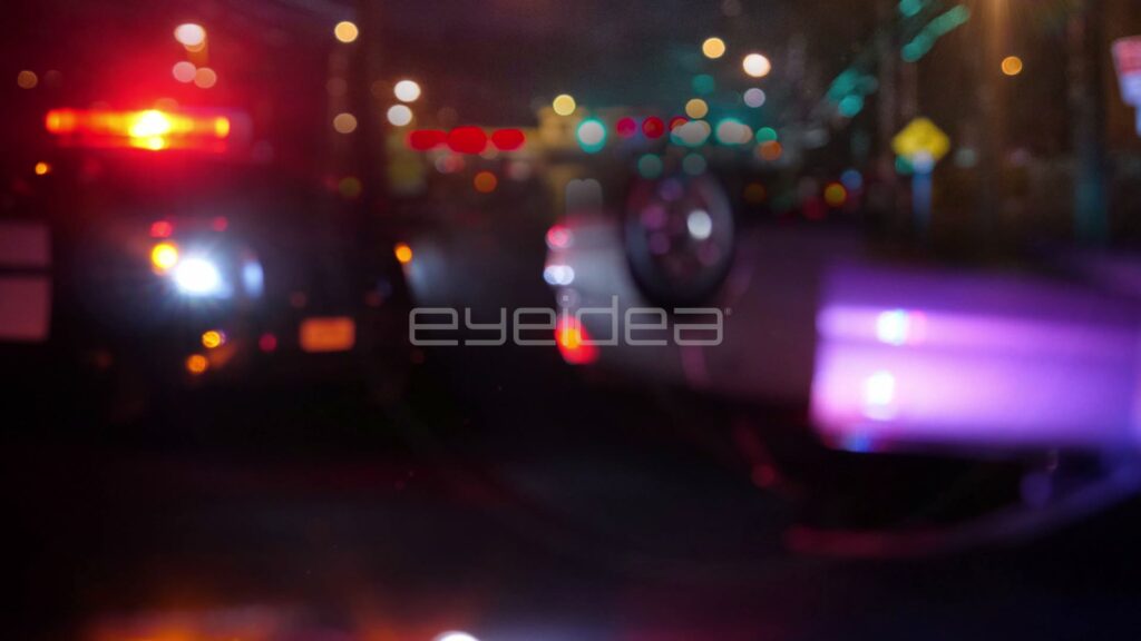 Upside-Down Car Under Red Police Lights at a Night Crash