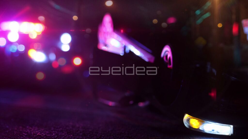 Close Defocused View of a Flipped Car and Police Lights