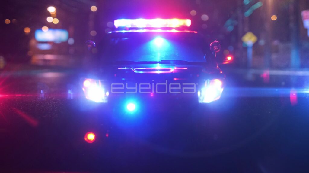 Head-On Police Cruiser Lightbar on a Hazy City Street