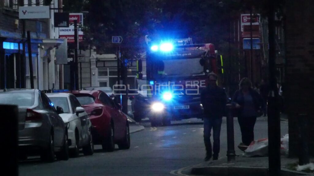 Fire Engine with Blue Lights Responds at Night in London
