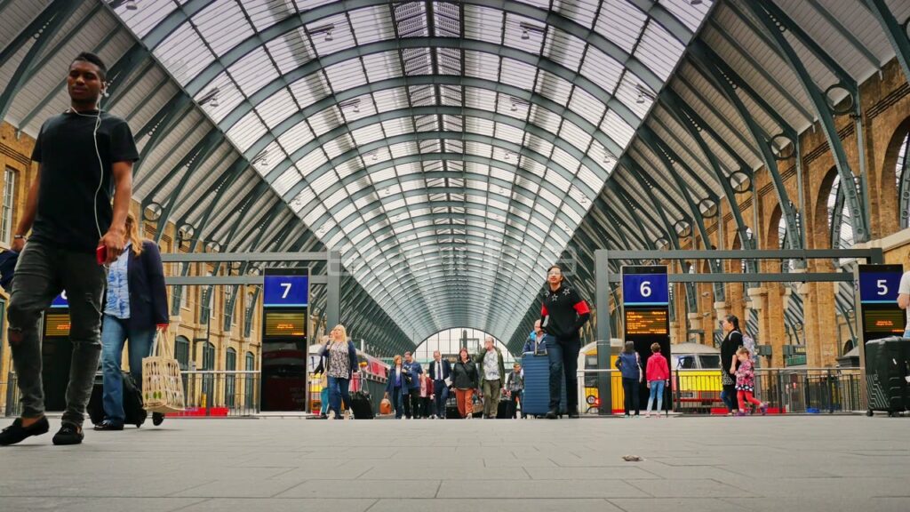 Travelers Walk Under Arched Roof at King's Cross Station
