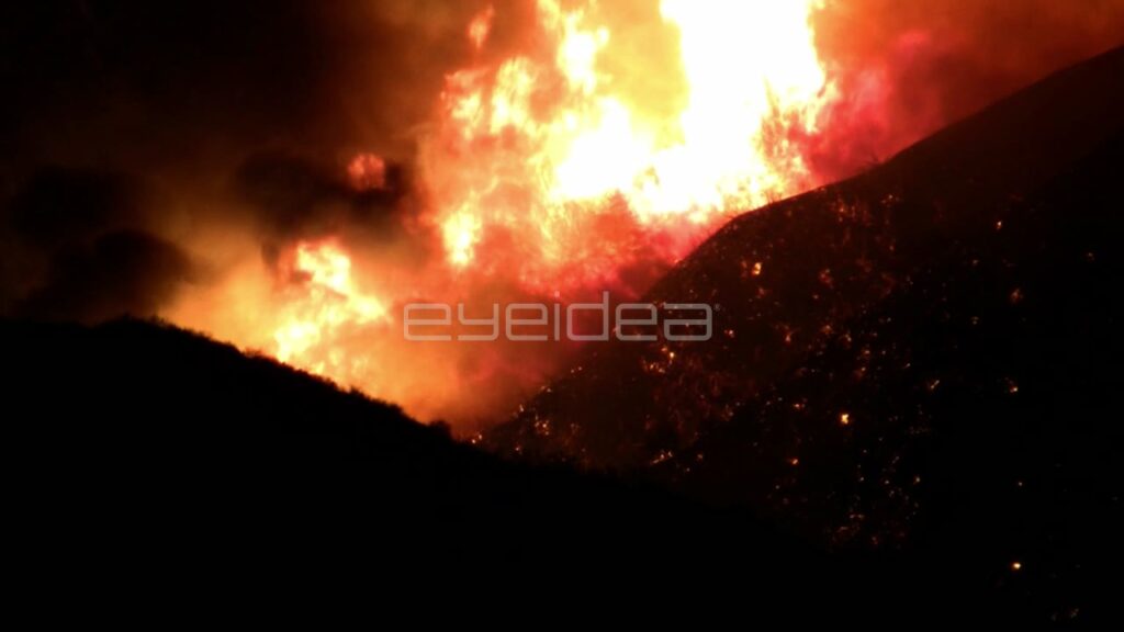 Large Wildfire Flames Raging on Dark Hillside at Night