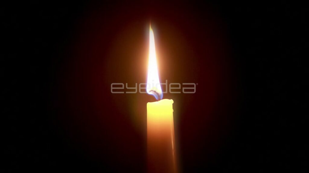 Single Orange Candle Flame Burning in the Dark
