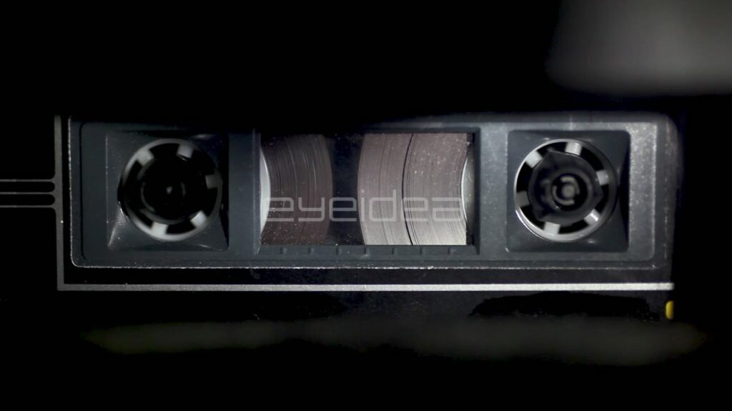 Macro Close-Up of Magnetic Tape Spinning in Cassette