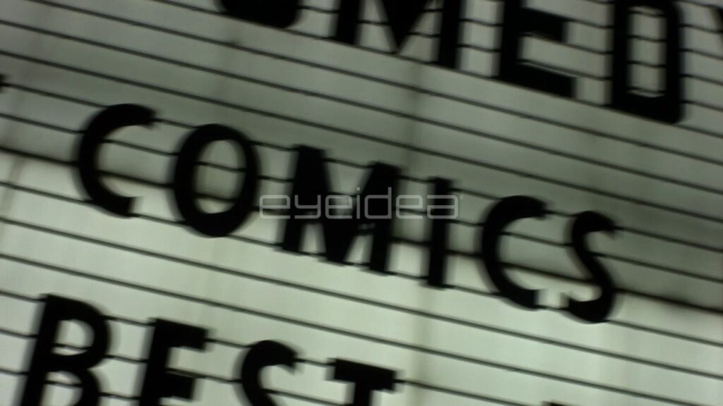 Dynamic Dutch Angle Pan of Comics Marquee Sign