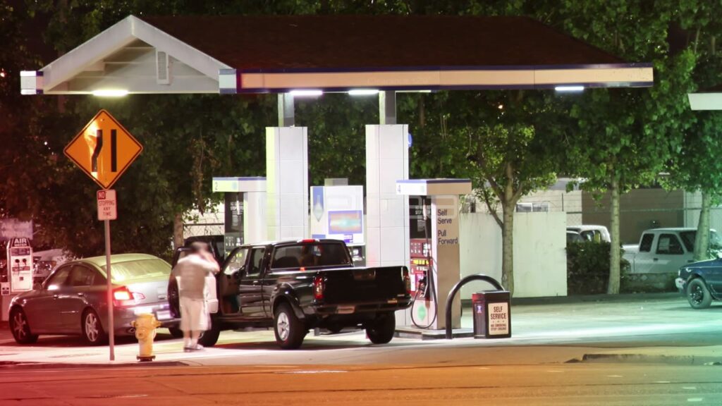 Time-Lapse of Night Traffic at Gas Station with Warm Lighting