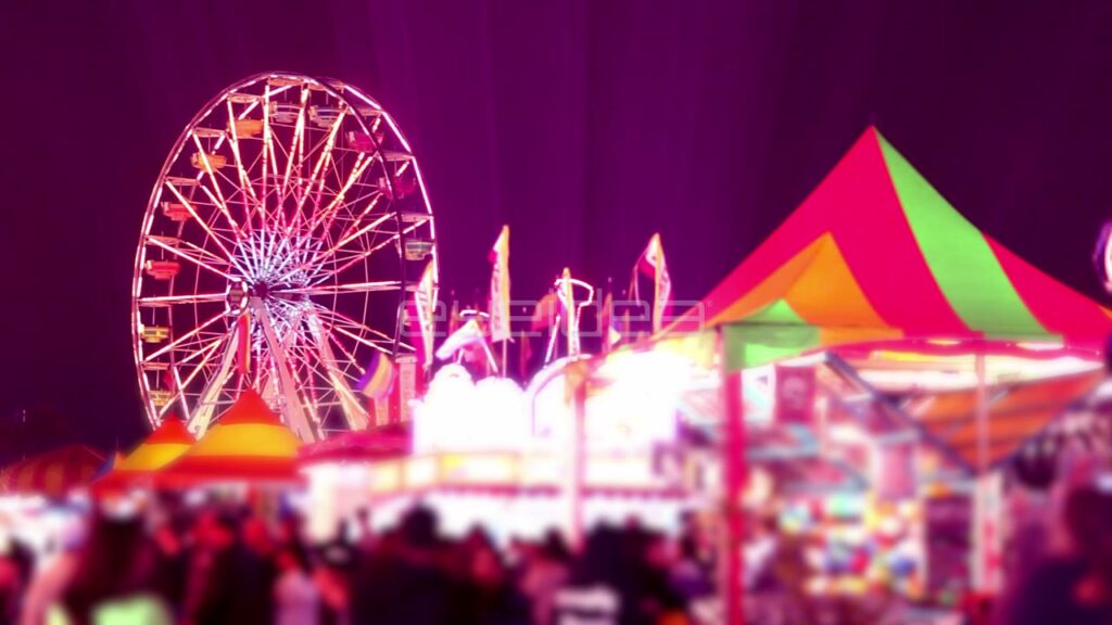 Ferris Wheel and Carnival Stalls at Night with Pink Glow