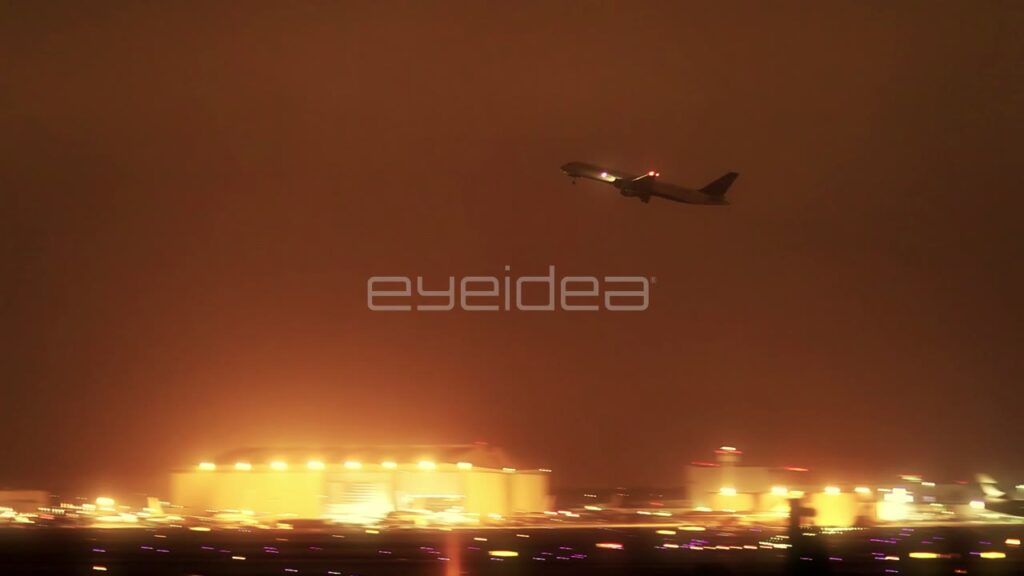 Jet Airliner Taking Off at Night with Warm Haze