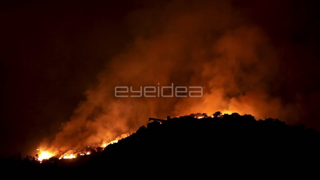 Time-Lapse of Wildfire Burning on Hillside at Night
