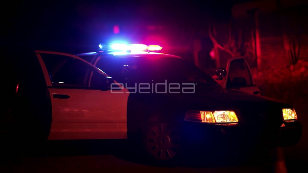 Police Car with Flashing Red and Blue Lights at Night