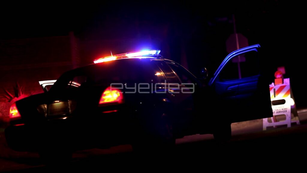 Black and White Police Car with Flashing Lights at Night