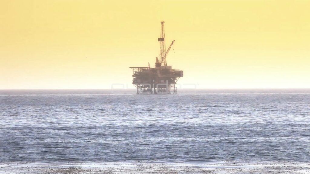 Offshore Oil Rig Silhouette at Sunset in the Pacific Ocean
